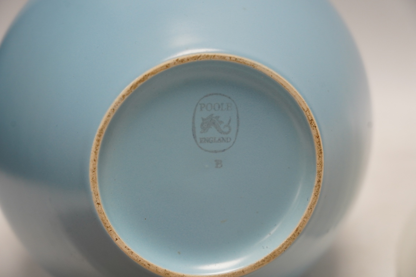 A Poole pottery Aegean ware bowl and dish, a light blue glazed vase and a John Harlow stoneware dish, vase 21cm. Condition - good